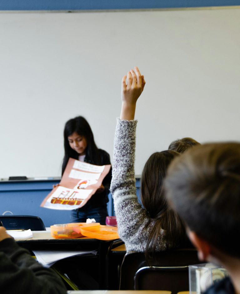 student raising her hand